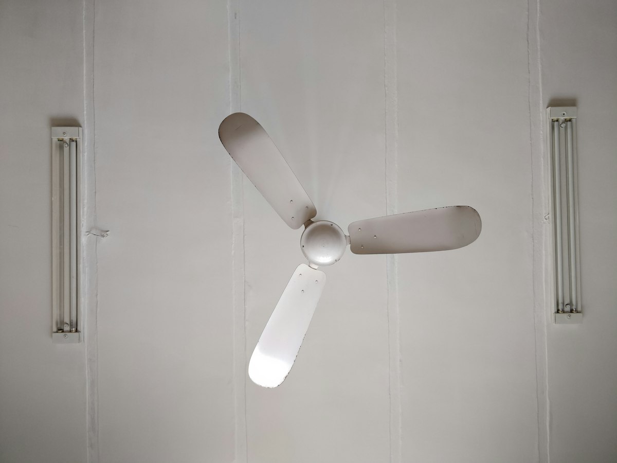 White three-blade ceiling fan mounted on a clean white ceiling