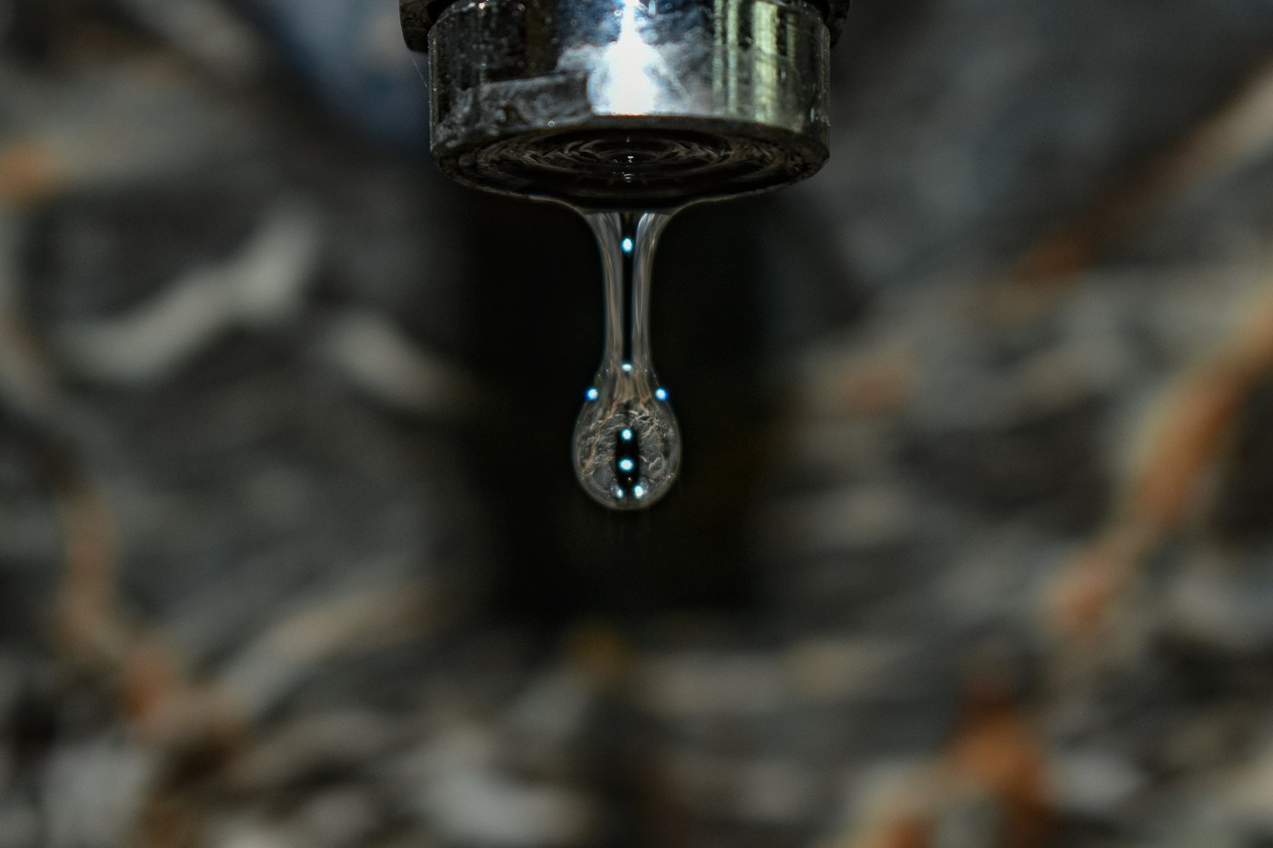 Water dripping from a chrome kitchen tap that needs a new washer