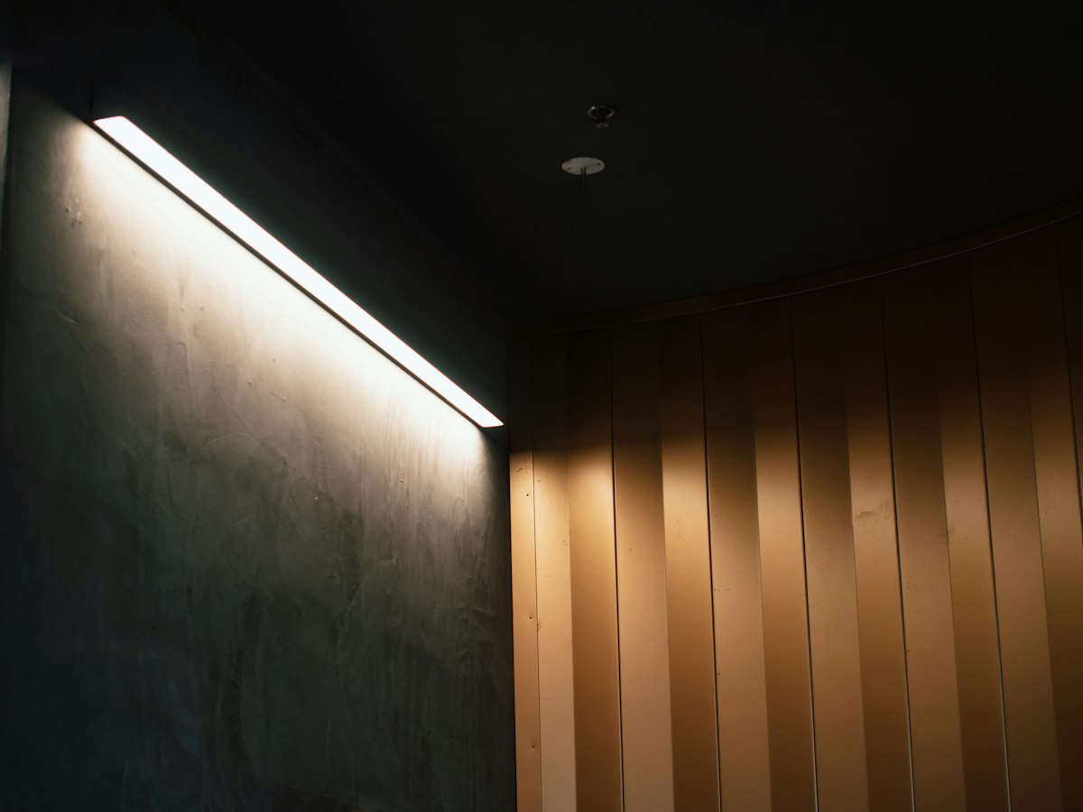 Soft LED strip lighting glowing along a dark ceiling edge