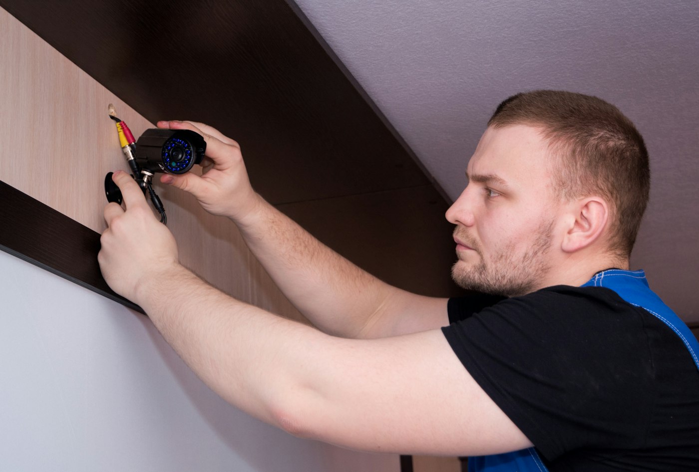 Technician installing a ceiling light fitting in a customer's flat